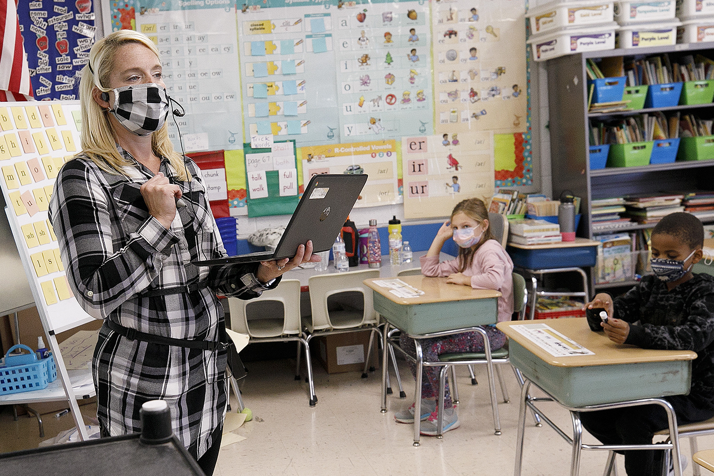 Teacher Carlin Daniels instructs a math lesson while using a laptop to communicate with remote learning students in her second-grade classroom at Casimir Pulaski Elementary School in Meriden, Conn., Thursday, Sept. 30, 2021. (Dave Zajac/Record-Journal via AP)
